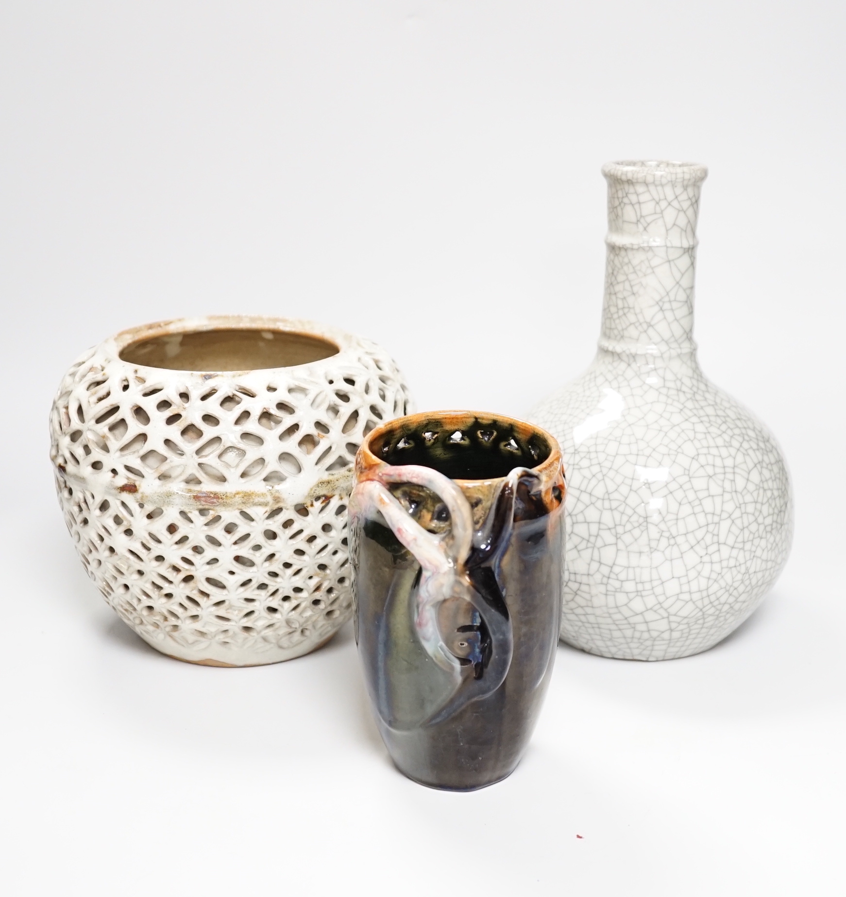 A Chinese crackle glaze bottle vase, a reticulated pottery vase and pottery vase, tallest 23cm high